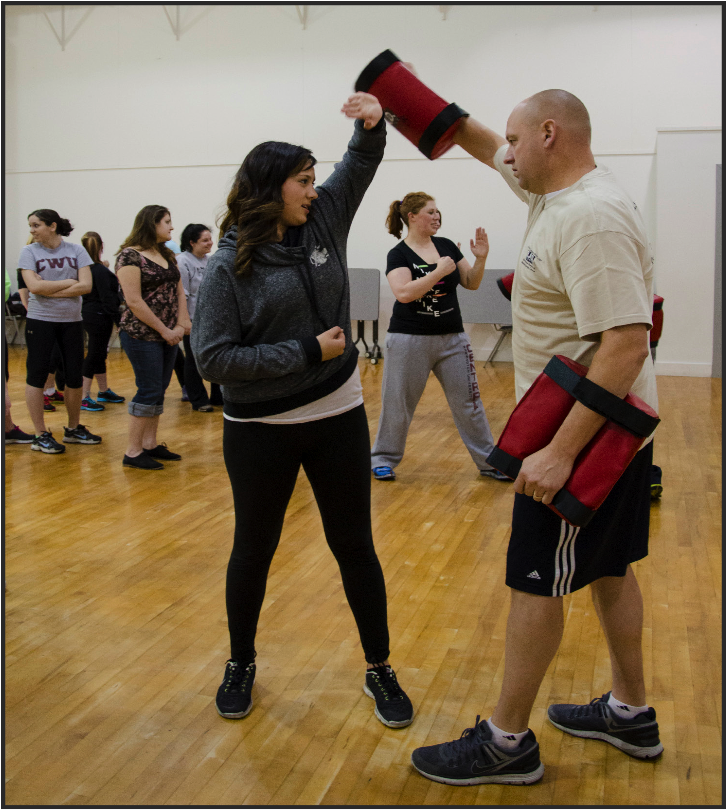 Female students learn self defense with university class 