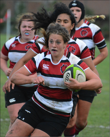 DETERMINATION - Captain Heather Johnson muscles her way through the defense. 

Johnson is a 56 senior forward (hooker) from Dixmont, Maine  and has played rugby for four years. 
