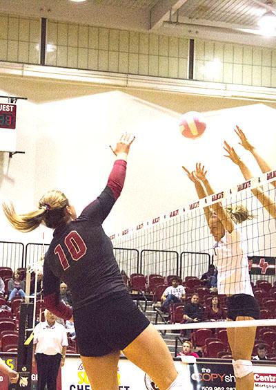 SPIKE - Redshirt junior Kaitlin Quirk looks for a hole between the blockers.