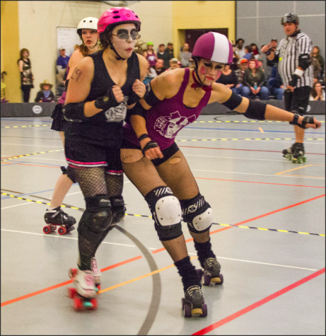GET OUT THE WAY - Members of the Rodeo City Rollergirls battle it out during their Halloween bout. 