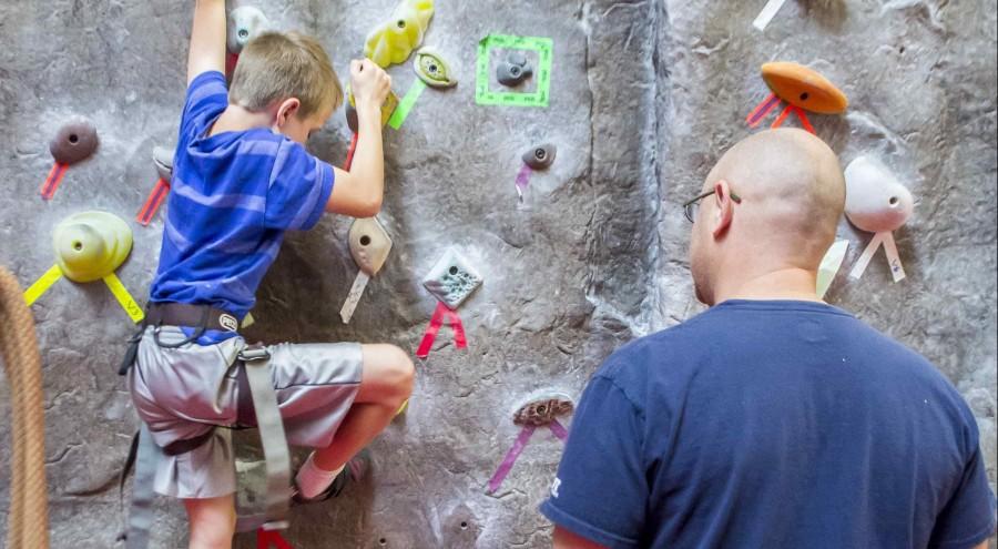 Kids and parents using the rock climbing wall