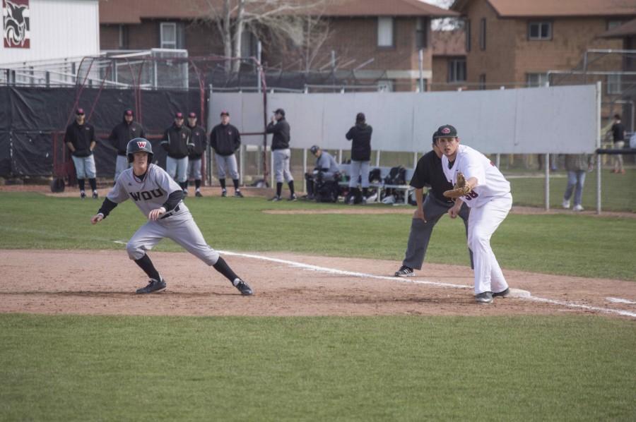 Western Oregon University player leads off as junior first baseman Randy Fuller looks to make a play. 