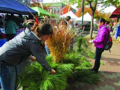 Volunteers help replant the downtown planters during the last Make a Difference Day.