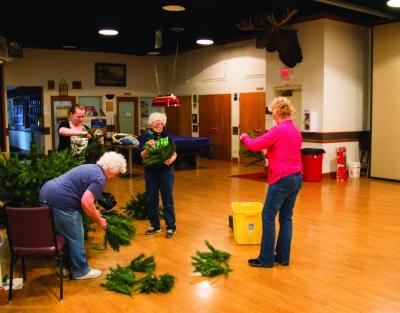 Volunteers at the Moose Lodge begin to set up the Christmas tree in preparation of the holiday season