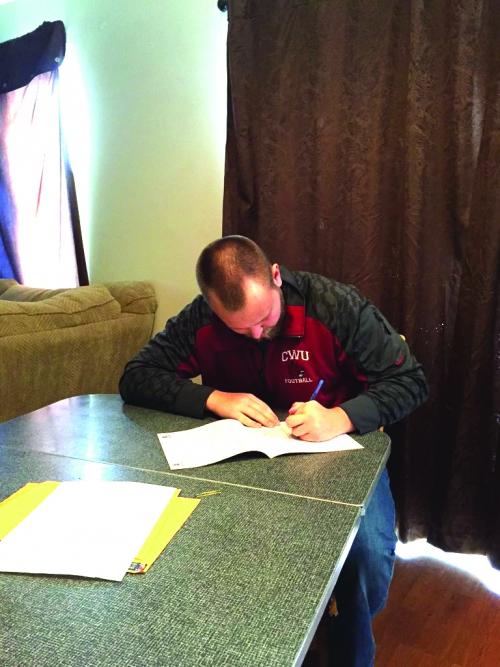 Centrals longsnapper Jason Diffee signs papers to get an NFL agent.