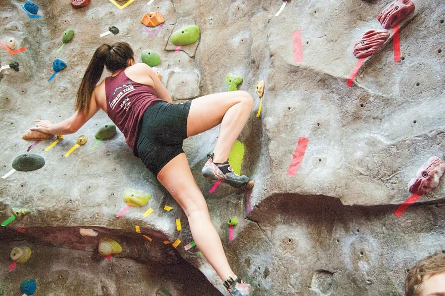 Junior Allison Newcomb works her way up Centrals climbing wall.