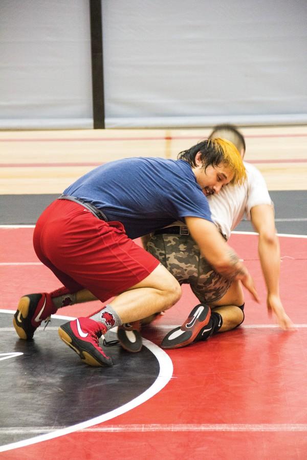 Jake Ferris takes his opponent down to the mat during Centrals club wrestling practice