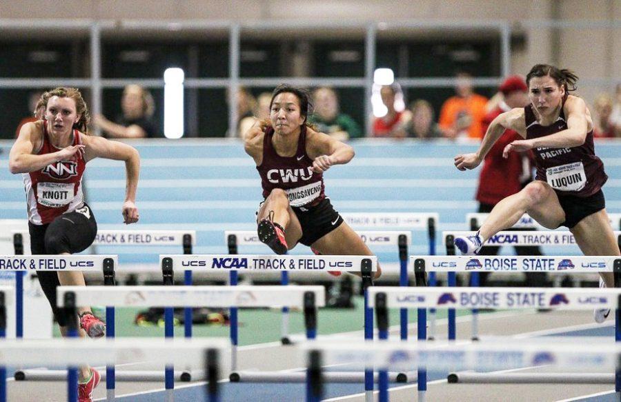 Mariyah Vongsaveng runs over a hurdle during a competition. She now holds the GNAC record.
