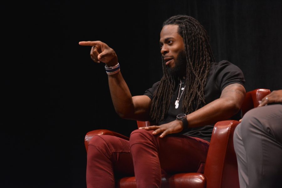 Seattle Seahawks cornerback Richard Sherman points to the crowd after an audience member shouts out his alma mater, Stanford University.