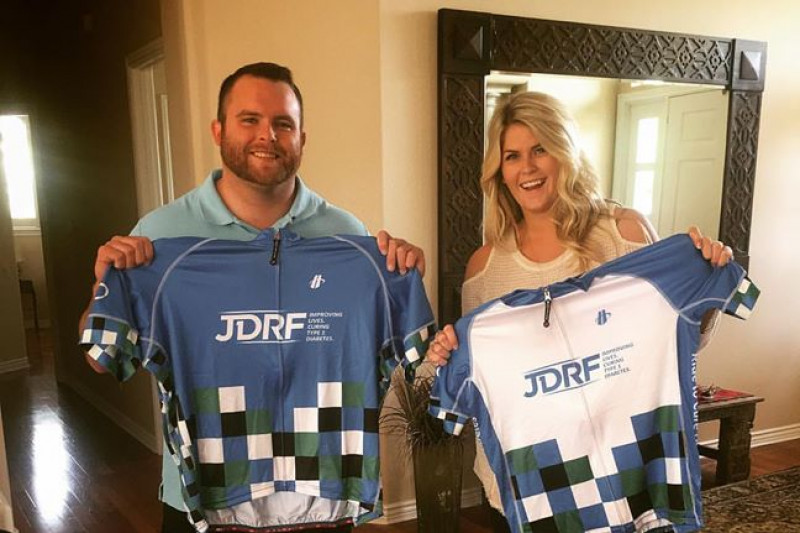 Justin Mann (left) and Ashtyn Mann hold their JDRF-sponsored jerseys for their upcoming cross-county bike trip.