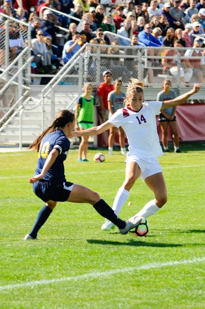 Mackenzie Nolte going around a defender during a 3-0 win over Montana State Billings.