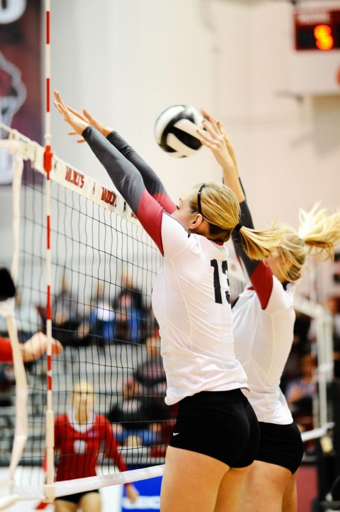 Now graduating Kiah Jones (13) and her teammate going up for a block during a game.