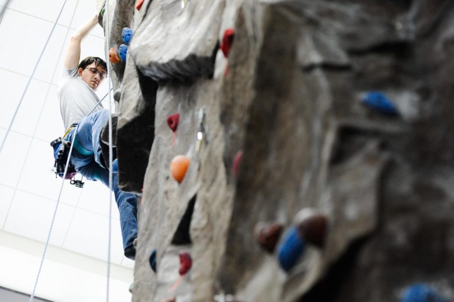 Martin Mattes scales the rock wall in the SURC Recreation Center for the Vertical Challenge. 