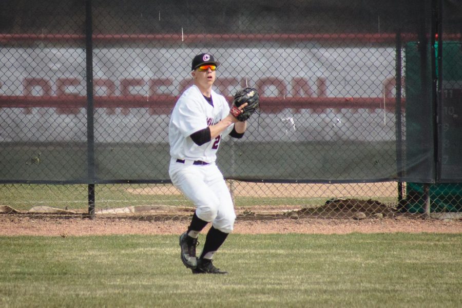 Outfielder Tristin Parton catches pop fly and attempts to throw runner out at second base against Montana State University of Billings.
