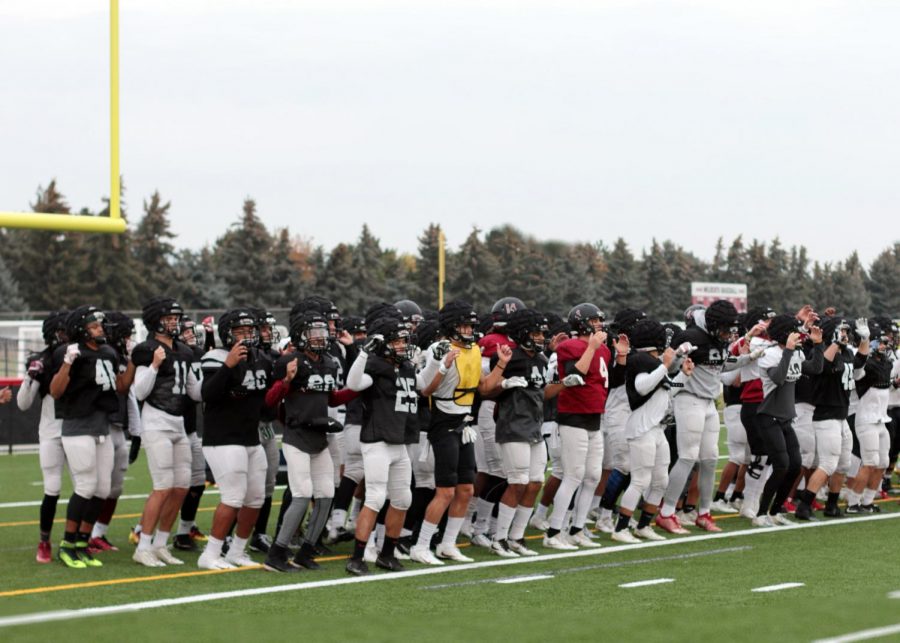 CWU Football chants Football as they warm up at practice. The team has been named GNAC co-champions.