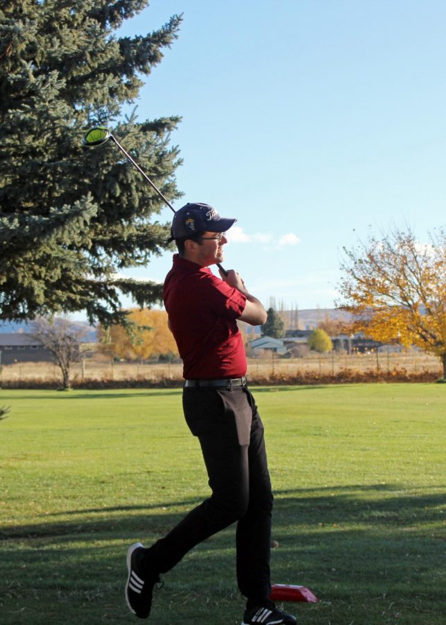 David Ellithorpe takes a practice swing at the Ellensburg golf course during Sunday practice to prepare for nationals.