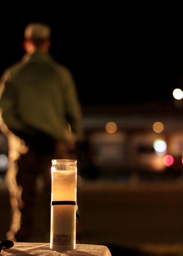 Air Force ROTC Eddie Marx holds his position in silence as as he honors those MIA and the POW during the 24-hour vigil on Sunday night. A candle burns as the cadets hold a position of honor for the veterans before them. 