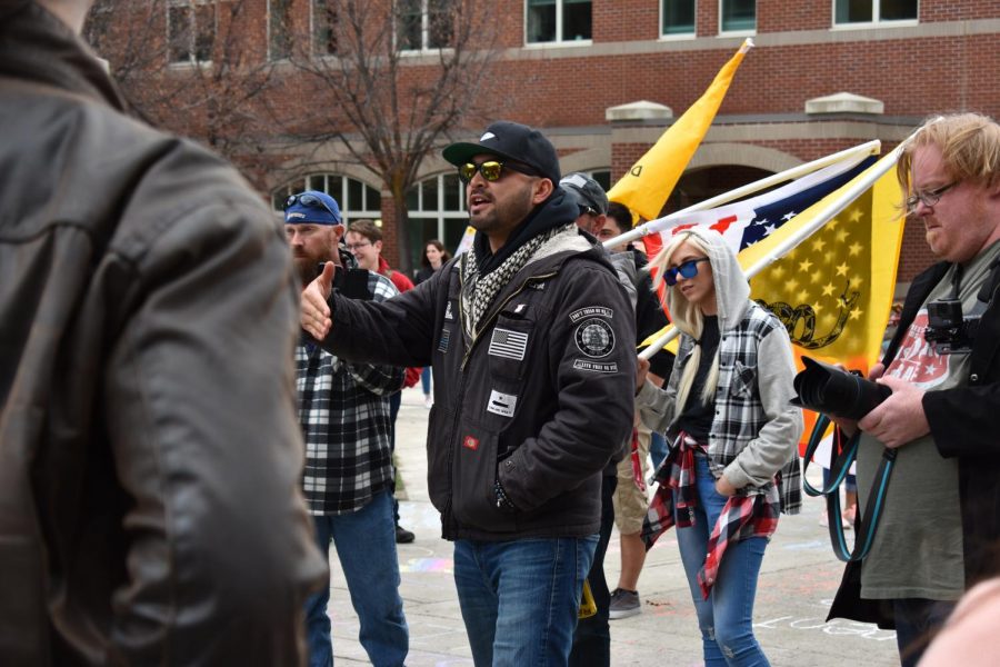 Patriot Prayer members debate with students. Joey Gibson, seen in front, is the founder of Patriot Prayer and helped lead Patriot Prayer through campus.