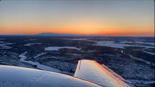Sunset over Point Mackenzie, Alaska from the cockpit of a Piper PA-30