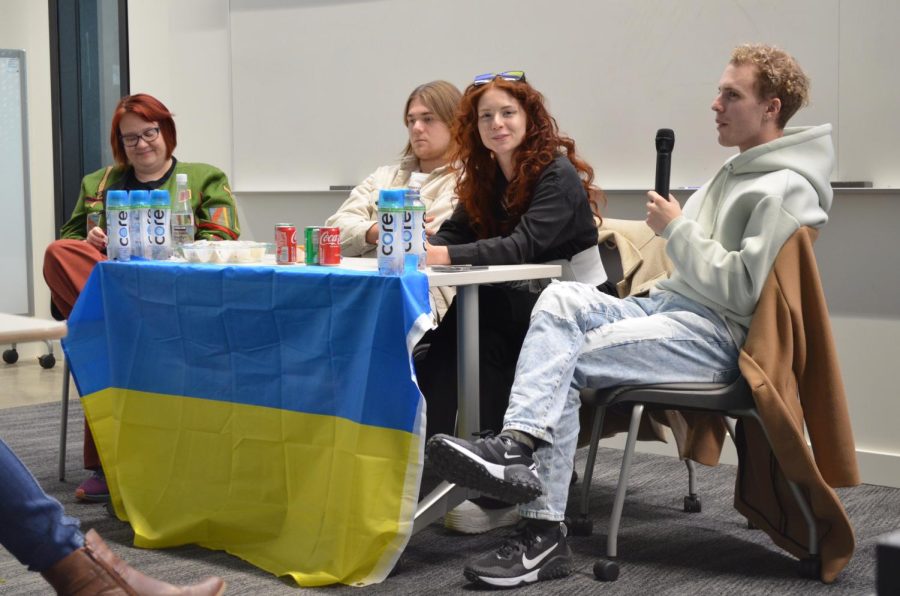 Muir Hamilton translates comments made by Vasilisa Gorislavets at the panel to support Ukraine on Oct. 28. L-R Dr. Volha Isakava, Vladislav Bulgar, Vasilisa Gorislavets, Muir Hamilton. 
