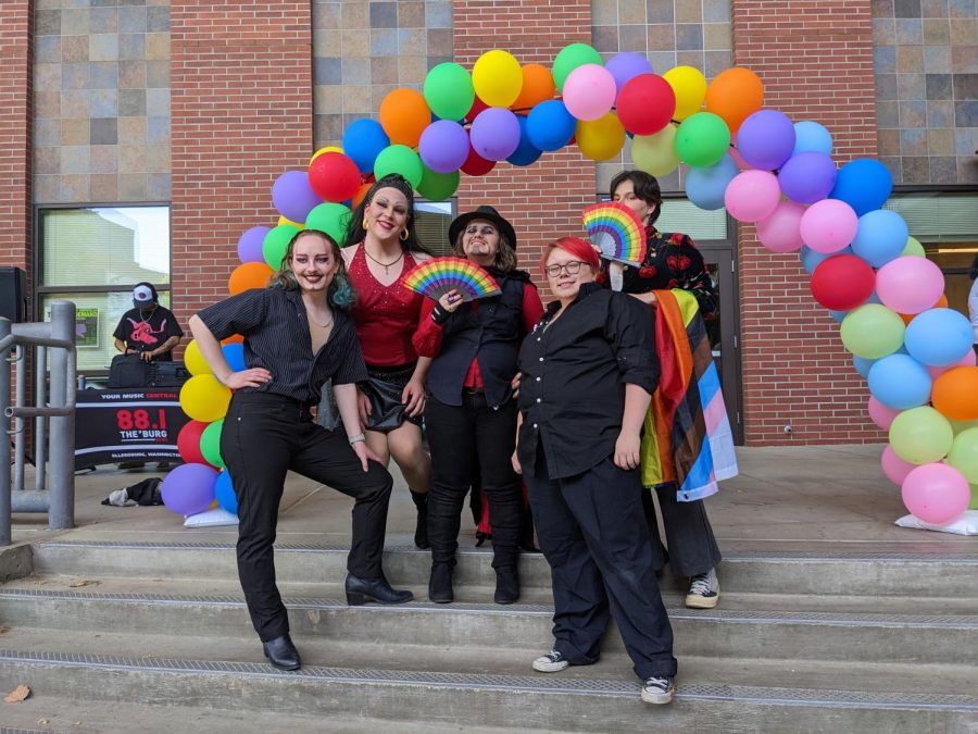 Amateur drag performers pose in front of a balloon of rainbows after leaving it all on the floor for the audience. Photo by Katherine Camarata