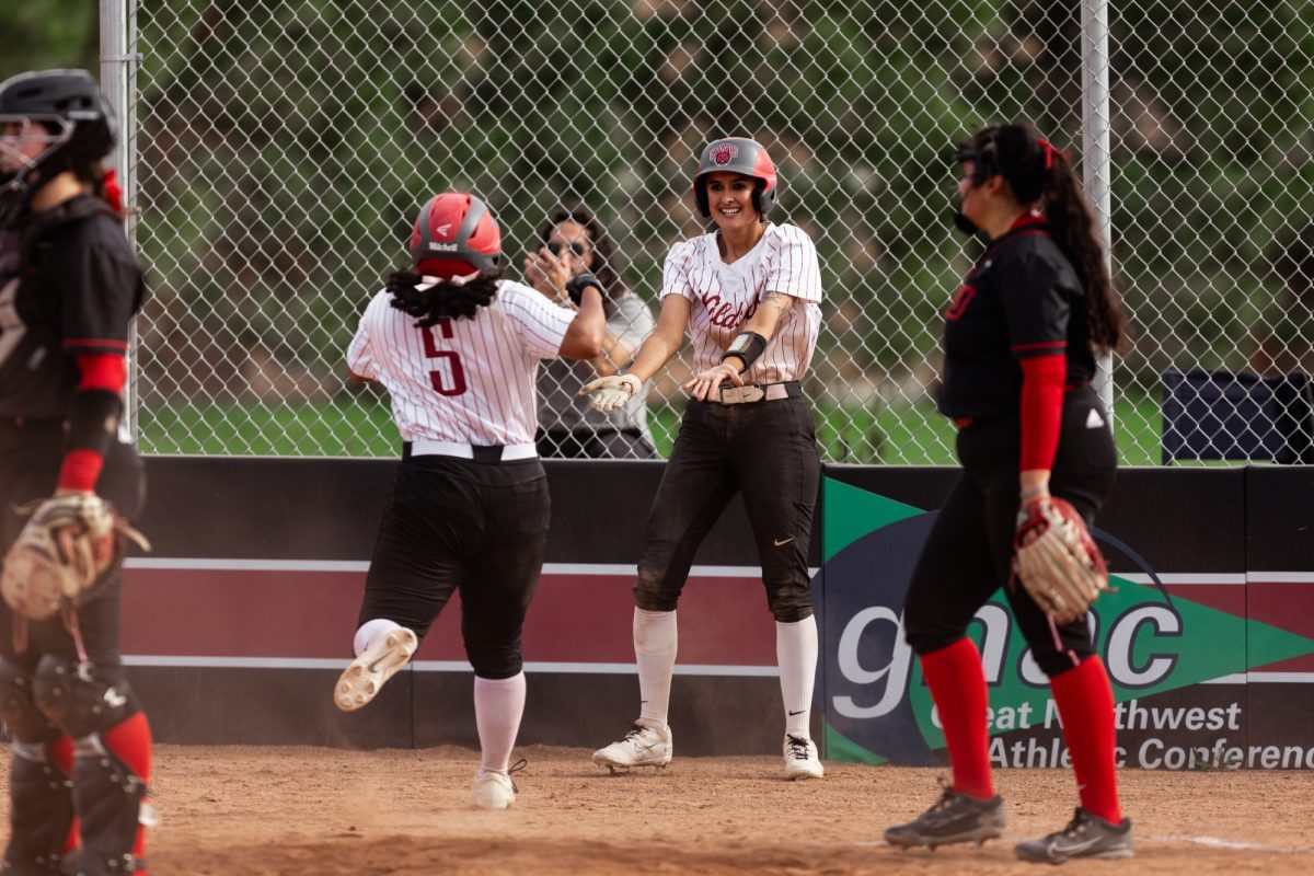 Redshirt junior Sasha Mitchell running to meet senior outfielder Jillian Hampson at home as she tacks on a run for the Wildcats.

(Photo courtesy of Jacob Thompson/Thompson Sports Media)