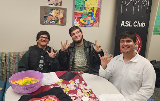 ASL Students Jose L Martinez III, Tevin Merlin and Jesus Chavez-Lara signing "I love you." (Photo by Astor Powell-Pederson)