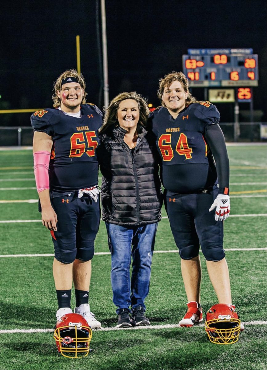 Gavin, Jaxin, and Tina McCallum after a high school game.