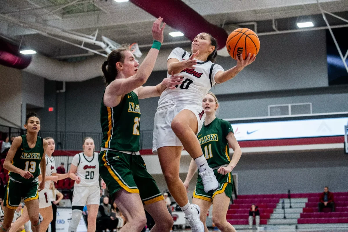 Sunny Huerta (Right) fighting through Anchorage defenders. 