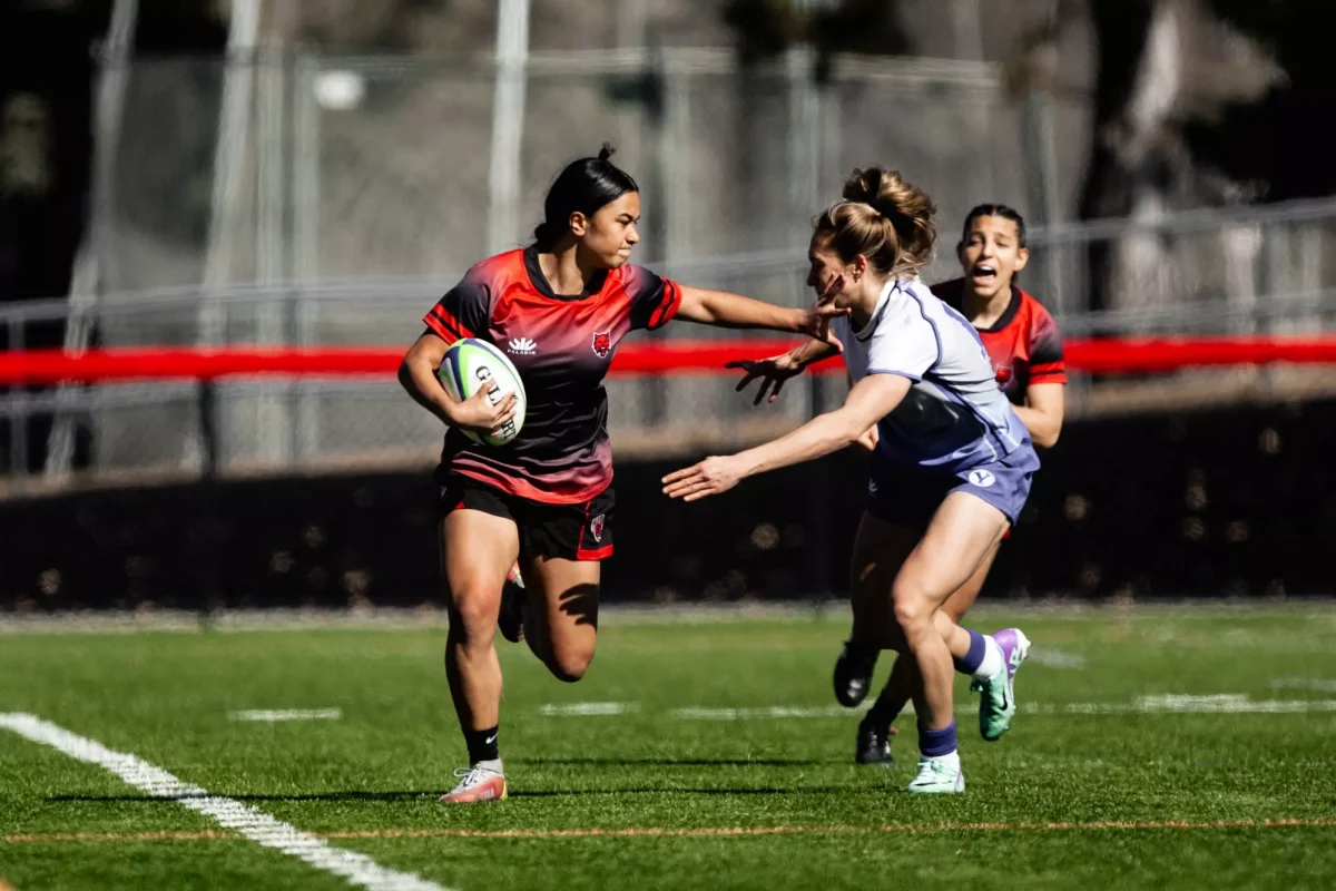 Ana Eteuni pushing BYU defender away.