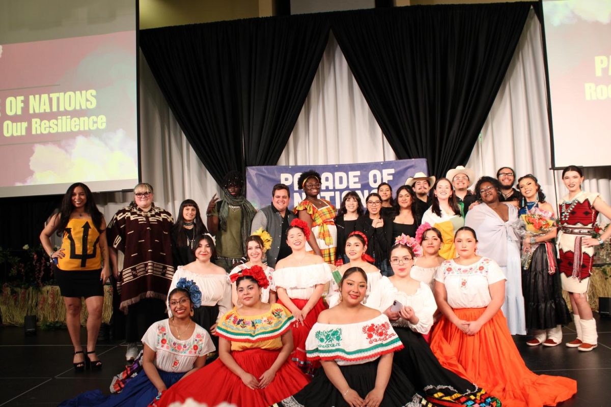 Parade of Nations pose for group picture on SURC ballroom stage. Photo courtesy of Alisia Sanchez