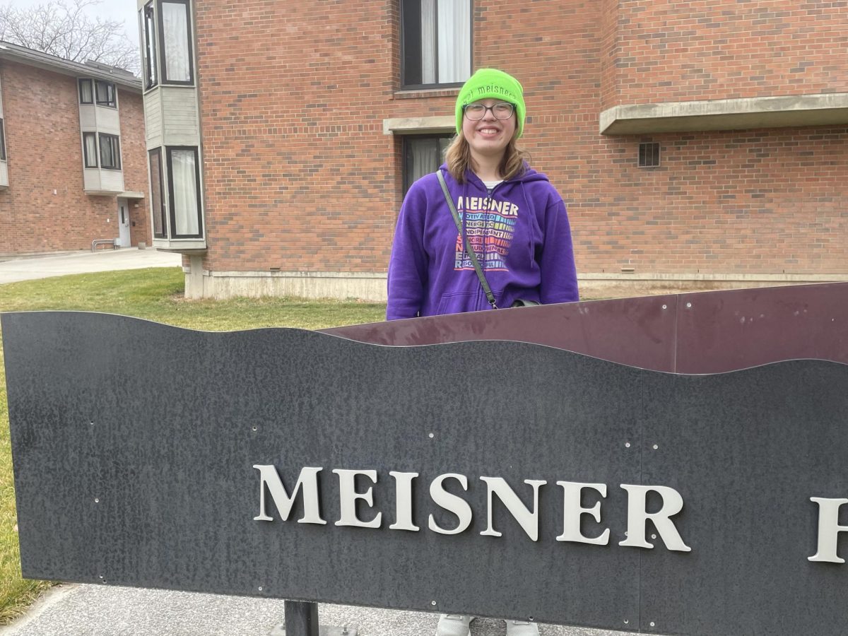 Me by the Meisner Hall sign in my Meisner merch.